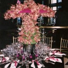 Orchids arranged to cover pink parasol umbrellas in NYC arrangement